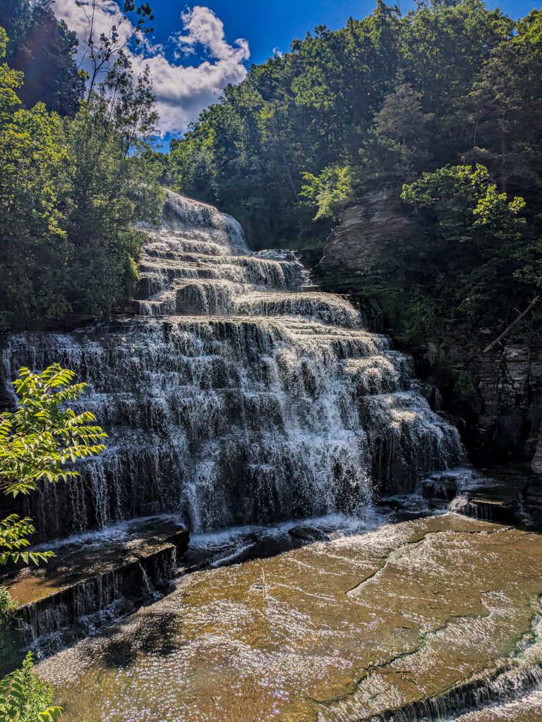 Hector Falls cascading down rock cliffs along the highway near Seneca Lake